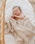Sleeping baby wrapped in Haze cotton knit blanket