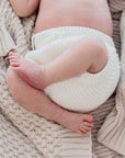 Baby's feet lying on Haze cotton knit blanket